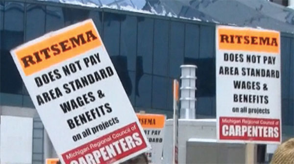 Images from 
Union Bosses Outsource Hostility, Hiring Beneficiaries of Entrepreneur’s Charity to Protest His Business